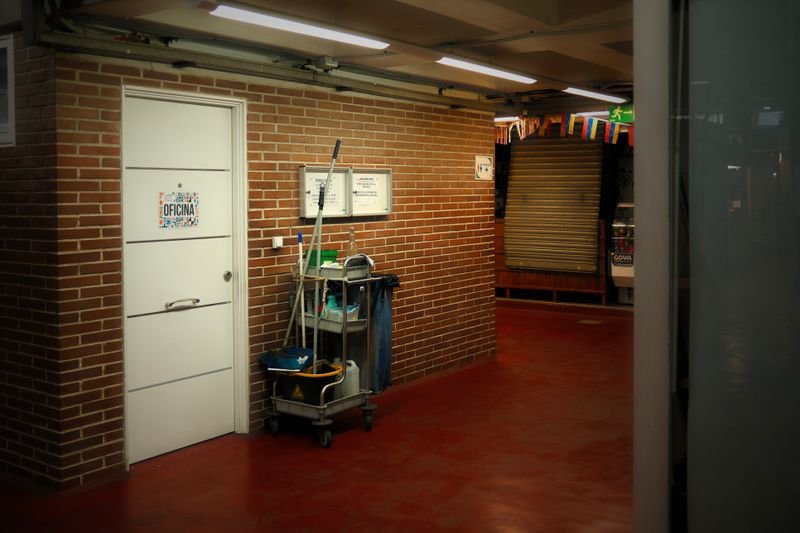 Cleaning cart and supplies in a commercial office hallway
